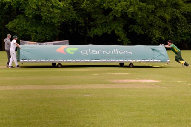 The covers go on the cricket pitch as the rain washed out any play at Sarisbury Athletic who were hosting OTs & Romsey. Picture: Paul Jacobs (160257-3)
