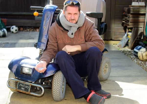 Nick Rundle with his old mobility scooter after it was attacked and broken by an 11-year-old boy. 

Picture: Allan Hutchings (160407-942)