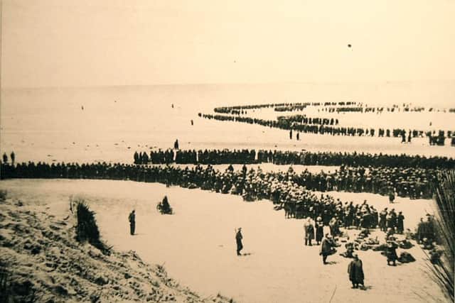 British and French soldiers on the beach and in shallow water at Dunkirk as they wait to be evacuated, 1940.
