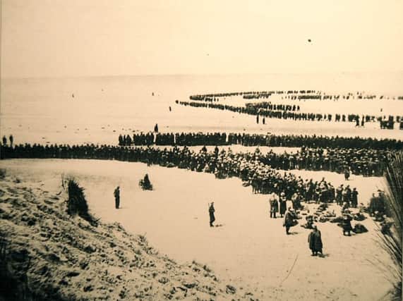 British and French soldiers on the beach and in shallow water at Dunkirk as they wait to be evacuated, 1940.