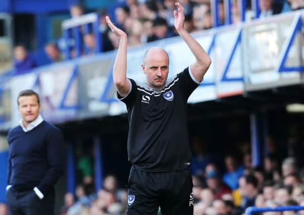 Pompey boss Paul Cook shows his appreciation to the Fratton faithful Picture: Joe Pepler