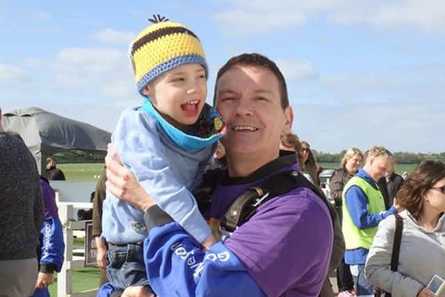 Steve Bonnick with his son Charlie after completing a skydive for the Rainbow Centre