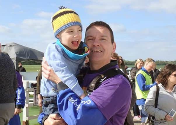 Steve Bonnick with his son Charlie after completing a skydive for the Rainbow Centre
