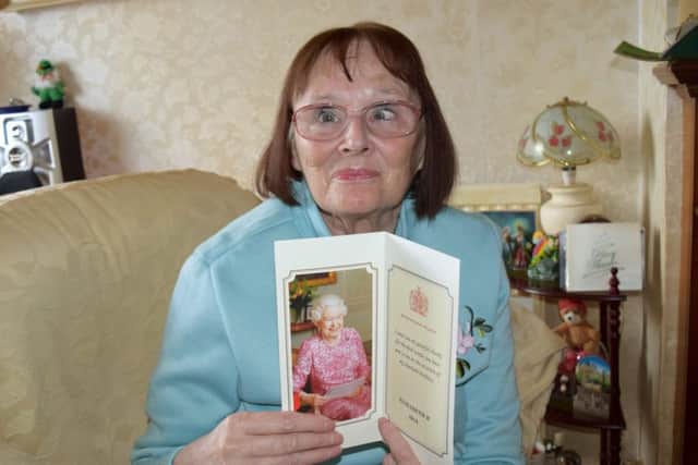 Jo Gander, 63, with her card from the Queen after writing her a poem.

Picture: Loughlan Campbell