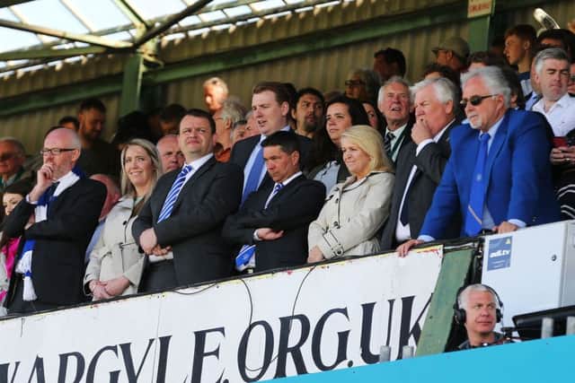 Mark Catlin, centre, and representatives from the Pompey board look on from the directors box at Plymouths Home Park