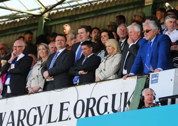 Mark Catlin, centre, and representatives from the Pompey board look on from the directors box at Plymouths Home Park