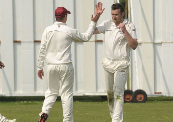 Conor Regan, right, celebrates a wicket as he was the pick of the Gosport Borough attack against Fair Oak Picture: Mick Young