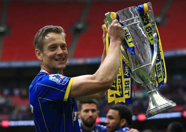 AFC Wimbledon's Paul Robinson with the Sky Bet League Two Trophy