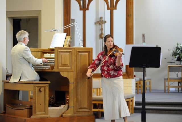 Sarah Sanders playing the violin and Peter Hallam on the piano
at the free lunchtime concert at Holy Trinity Church in Fareham Picture: Malcolm Wells (160531-5762)
