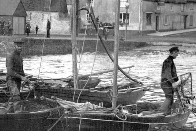 Two oystermen aboard  their boats at Emsworth.