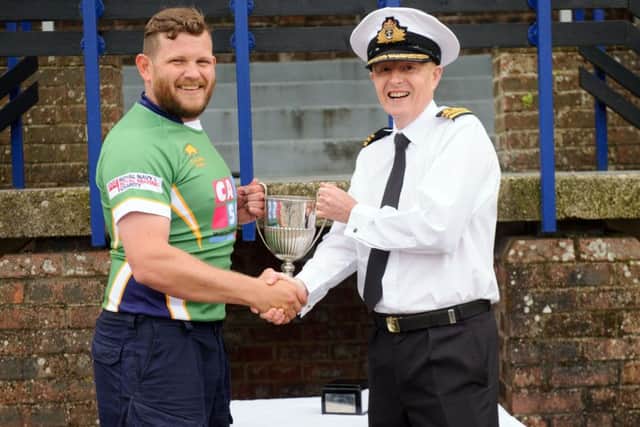 Field gun crew A winning captain Danny Johnson is presented with the 12 Pounder Cup by executive officer David Johnston Picture: Allan Hutchings (160420-023)