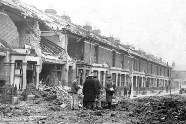 Ewart Road, Buckland, Portsmouth, after the Luftwaffe had paid another visit. Note the girl leaning against the lamp post talking to a friend and the dog in the distance.