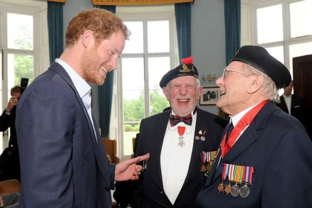 Prince Harry talks to veterans Joe Cattini (93) from Fair Oak and Denys Hunter (92) from Romsey. Picture: Sarah Standing (160749-1444)
