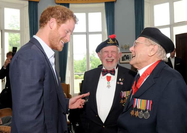 Prince Harry talks to veterans Joe Cattini (93) from Fair Oak and Denys Hunter (92) from Romsey. 

Picture: Sarah Standing (160749-1444)