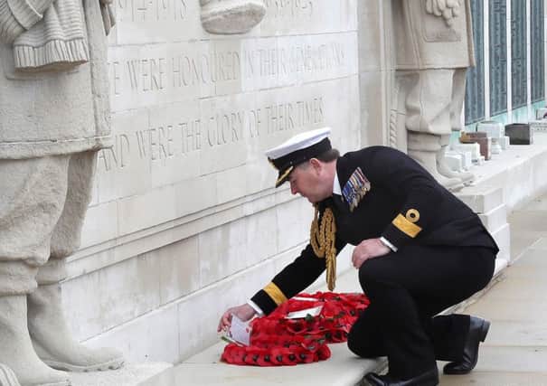 Commodore Jeremy Rigby, Portsmouth Naval Base commander, lays a wreath at the war memorial on Southsea Common