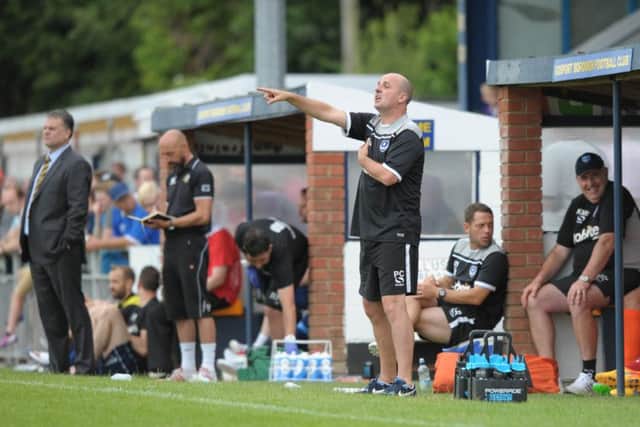 Pompey boss Paul Cook, centre, taking in last year's pre-season fixture with Gosport Borough    Picture: Steve Reid Blitz Photography