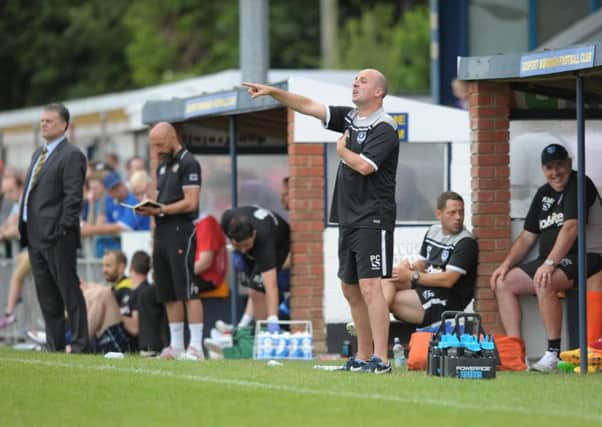 Pompey boss Paul Cook, centre, taking in last year's pre-season fixture with Gosport Borough    Picture: Steve Reid Blitz Photography