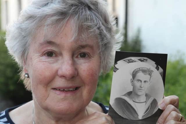 Jackie Baynes with a portrait of her grandfather William Cake
Picture: Ken Amer/PA Wire