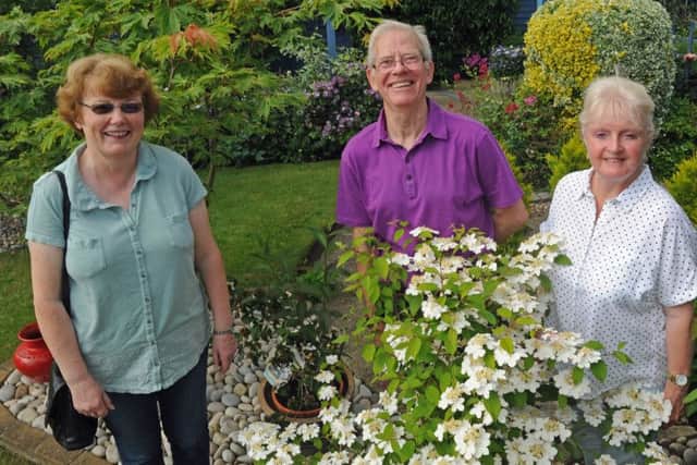 Visitor Jean Marchant with Keith and Teri Sandy in their garden