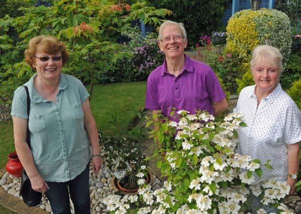 Visitor Jean Marchant with Keith and Teri Sandy in their garden