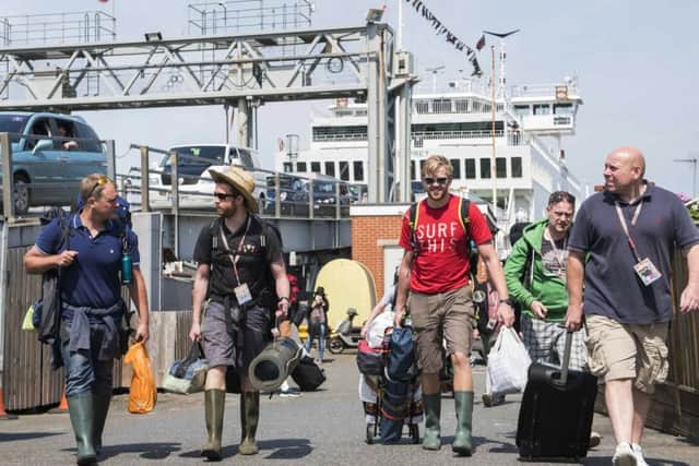 Festival-goers arrive at the Isle of Wight Festival