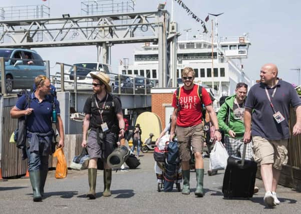 Festival-goers arrive at the Isle of Wight Festival