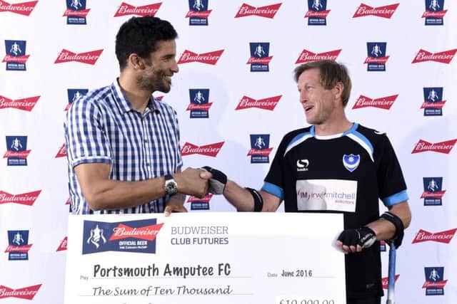 David James, presents a cheque for Â£10,000 to Portsmouth Amputees striker and Budweiser Dream Goal runner-up Ray 'Spike' Westbrook