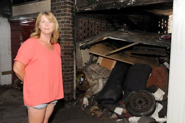 Debbie Ricketts (54) from Havant, next to her garage which was broken into around the 26th May where precious family items stolen and then was set on fire. Picture: Sarah Standing (160801-1578)
