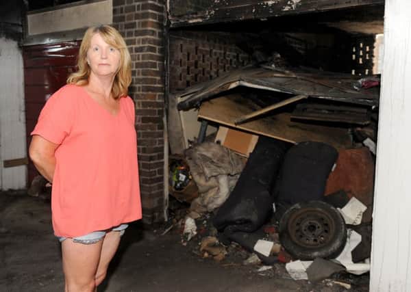 Debbie Ricketts (54) from Havant, next to her garage which was broken into around the 26th May where precious family items stolen and then was set on fire. 

Picture: Sarah Standing (160801-1578)