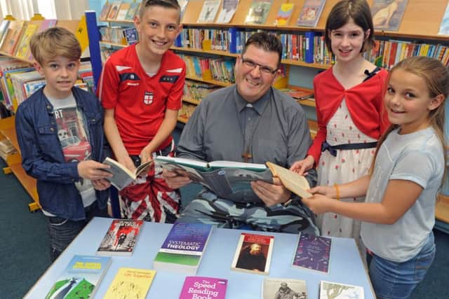 Reverend Sean Blackman with (left to right) Dylan Madeley (nine), Michael McLoughlin (11), Fern Carvey (nine), and Casey Galyer (nine)