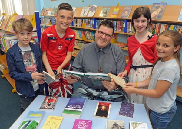 Reverend Sean Blackman with (left to right) Dylan Madeley (nine), Michael McLoughlin (11), Fern Carvey (nine), and Casey Galyer (nine)