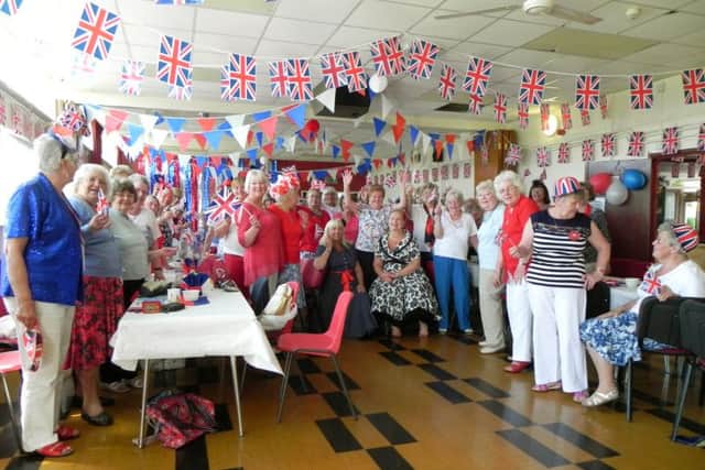 PATRIOTIC Members of the Ladybirds celebrate the Queens 90th birthday with Richard Woods colourful display of cup cakes below