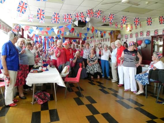 PATRIOTIC Members of the Ladybirds celebrate the Queens 90th birthday with Richard Woods colourful display of cup cakes below