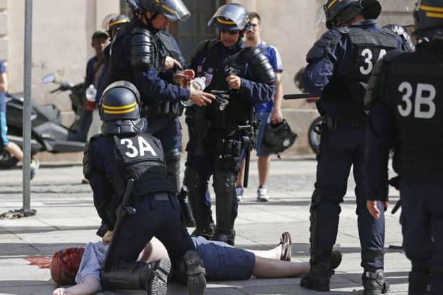 An England fan, believed to be Andrew Bache from Portsmouth, is resucitated by police after being attacked in Marseille