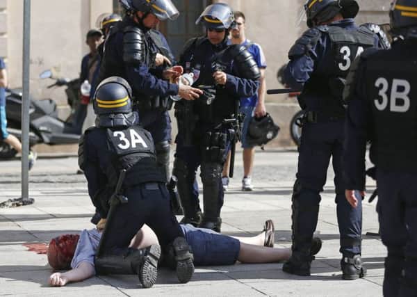 An England fan, believed to be Andrew Bache from Portsmouth, is resucitated by police after being attacked in Marseille
