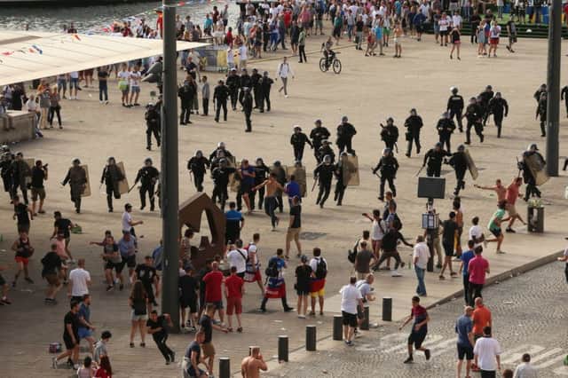 French riot police move in to arrest Russian fans after they clashed with England supporters in Marseille