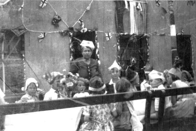CAKE The Smiths View street party for George Vs Silver Jubilee. The woman is Mrs Dorey. To her right is George Mason. In front of her is Philip Mason eating cake.