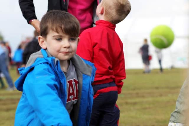 Pictured: Zachary Drew throwing a tennis ball to win sweets for the stall / Picture by LPhot Sean Gascoigne