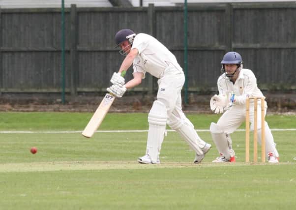 Tom Benfield batting for Portsmouth & Southsea, while Tom May watches on for United Services.  Picture: Habibur Rahman (160902_8111)