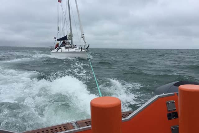 Gafirs tow a yacht back to shore