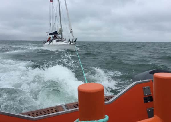 Gafirs tow a yacht back to shore