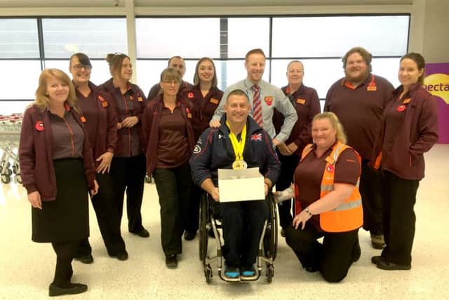 Invictus gold medal-winner Andy McErlean with staff from Sainsburys in Waterlooville
