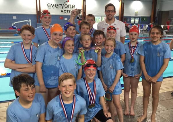 John Molyneaux with the winning swimmers at the schools' gala