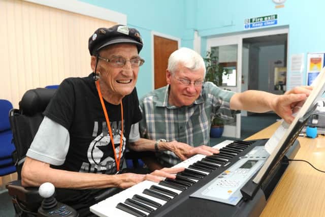 Gerald Williams is learning to play the organ to raise money for charity. Organ teacher Paul Taylor checks all is wellPicture: Ian Hargreaves  (160720-2)