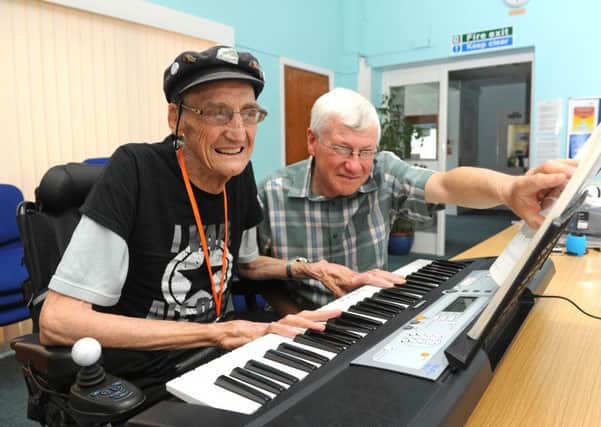 Gerald Williams is learning to play the organ to raise money for charity. Organ teacher Paul Taylor checks all is well
Picture: Ian Hargreaves  (160720-2)