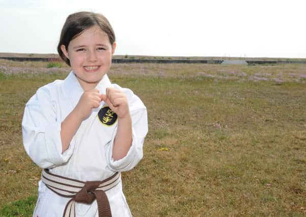 Josie Parrott, nine, from Hayling Island, aims to complete 3,000 karate kicks in an hour at fundraiser for a sarcoidosis charity after her grandmother Dawn Kilburn died of the condition two years ago.

Picture: Sarah Standing (160808-2118)