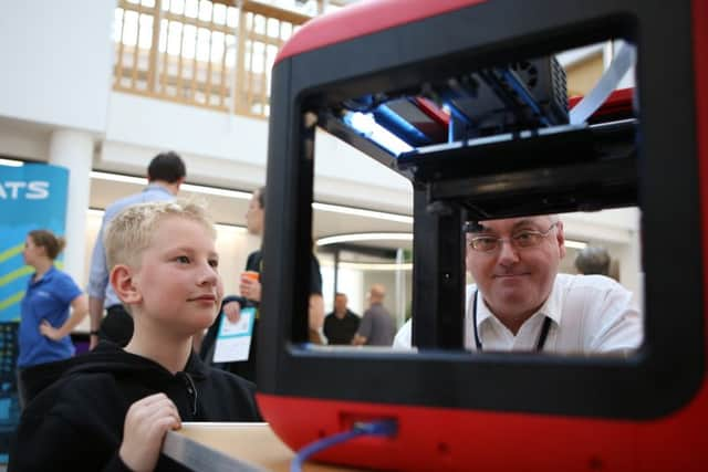 Daniel Hudson, 12, is shown how a 3D printer works by David Franklin

Picture: Habibur Rahman (160914-25)