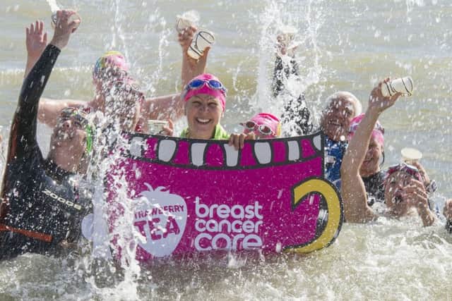 Asda Fareham's Community Champion Sharon Noble enjoys her Strawberry Tea with friends from her open water swimming club at Hill Head beach