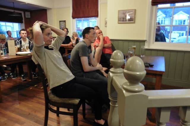 Glum fans look on at The Wicor Mill as England crash out of Euro 2016 to Iceland Picture: Jeff Travis