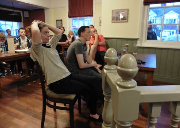 Glum fans look on at The Wicor Mill as England crash out of Euro 2016 to Iceland Picture: Jeff Travis